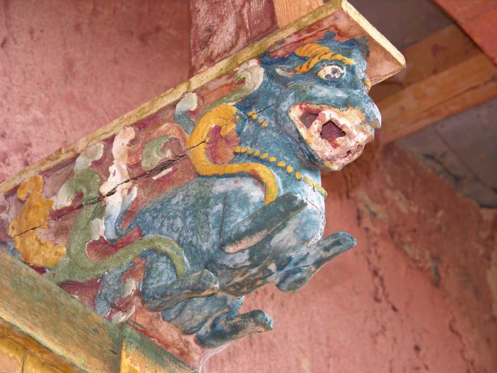 Tibet Guge 09 Tsaparang Demchog Temple 02 Carving on Roof Support Four main beams span the ceiling outside, each with charmingly carved figures underneath.